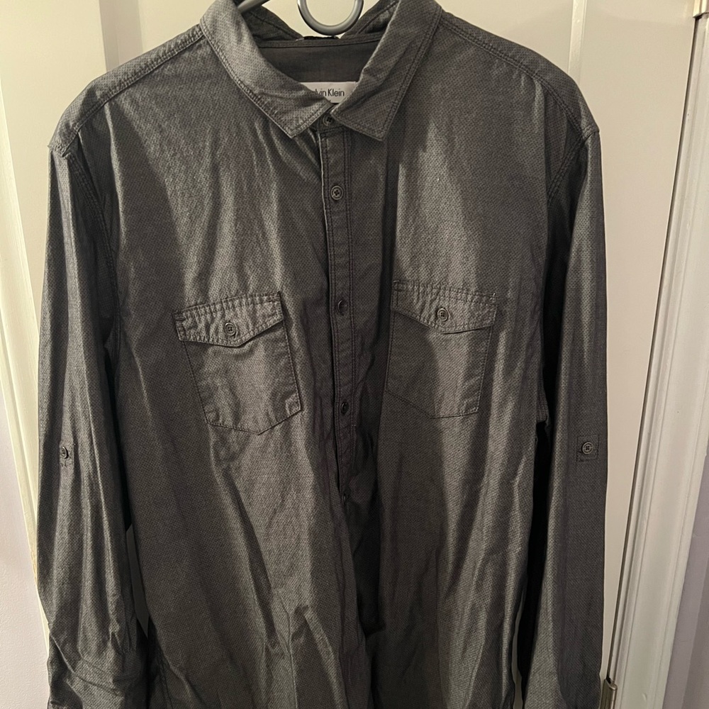 Gray long sleeve shirt with arm strap to roll up sleeves
